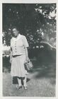 photo: middle-aged woman with checkered dress and purse and old car WU-D10-0113