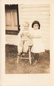 RPPC LITTLE DARK HAIRED GIRL ~ BLONDE BABY ~HIGH TOP SHOES c1910 POSTCARD 110625 - Picture 1 of 2
