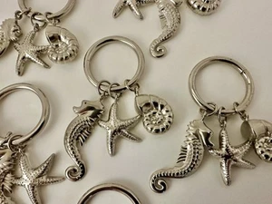 6 ~ Silver Tone 1.5" Napkin Rings Nautical Ocean Charms Seahorse Nautilus Star - Picture 1 of 3