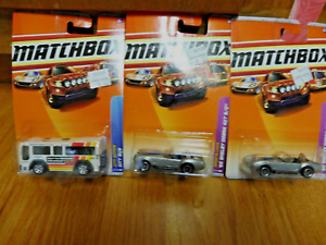  LOT OF 3 MATCHBOX VEHICLES NEW IN PACKAGES ( 2 SHELBY COBRA CARS & 1 CITY BUS)
