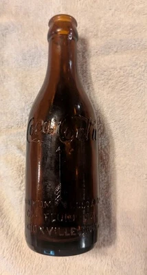 Bonita botella de Coca Cola ámbar lateral recto con flechas Knoxville, Tennessee Foto 1 de 4