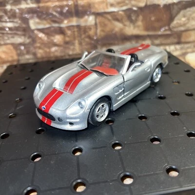 SHELBY New Ray 2000 SHELBY SERIES 1 Convertible  Silver And Red Stripes 1:32 /5” - Image 1 of 4