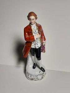 Vintage Porcelain Figurine Gentleman in Red Coat Holding Flowers Crown U Mark - Picture 1 of 10