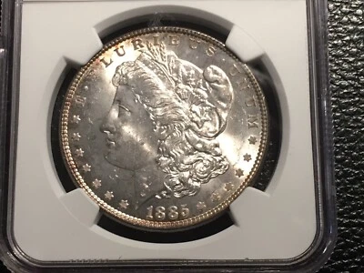 1885 morgan dollar NGC 64 uncirculated original gold rim toning  - Image 1 of 4
