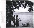 1965 Press Photo Girls On Shore, Watch Boat Cruise Past On Green Lake, Wisconsin