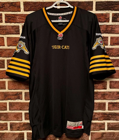 NEW Reebok HAMILTON TIGER-CATS Official CFL Football JERSEY Mens (M) Ti-Cats NEW Cover