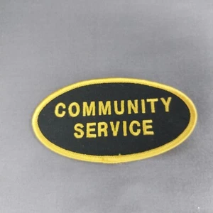 Parche para planchar Community Service negro amarillo ovalado 4"x2,5" - Imagen 1 de 2