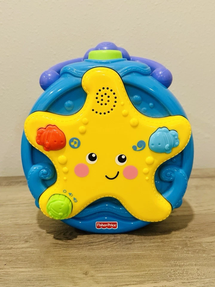 Chupete proyector Fisher-Price Ocean Wonders estrellas de mar para llevar cuna Foto 1 de 4
