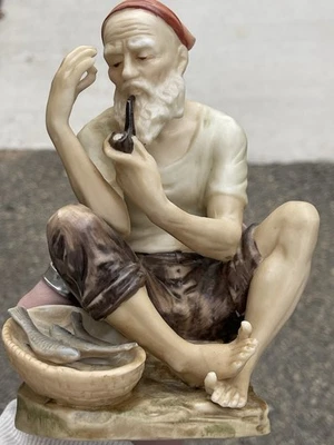 This is a vintage Capodimonte hand-painted porcelain figurine/seated fisherman - Image 1 of 4