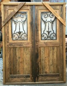 Double wooden Spanish door with hand forged wrought iron insert. X1240