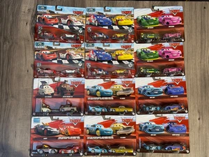 24 AUTOS LOT 12 x2 DISNEY PIXAR BOX CASE SEALED KABUTO DRAGON McQUEEN GRC DXV99 - Bild 1 von 3