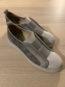 Stylish Gray and White Slip-On Sneakers on Wooden Surface - Picture 1 of 5
