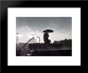 President Barack Obama takes the stage carrying an umbrella amidst the rain - Picture 1 of 1