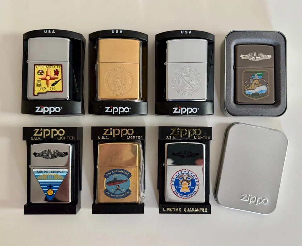 Ooh la la, BRAND NEW! Lot of 7 Vintage US Navy Ship Zippo Lighters - Image 1 of 4