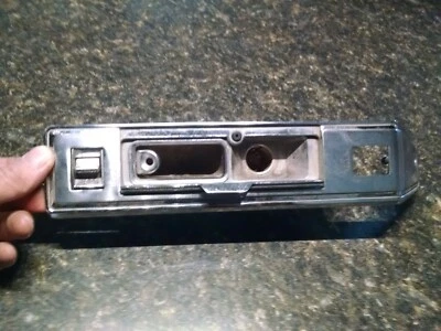 71-73 Cadillac Interior arm rest switch metal surround - Image 1 of 3