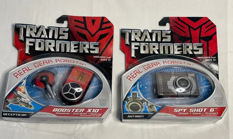 NIB Lot Of 2 Transformers Real gear Robots Spy Shot 6 Camera~ Booster X10~2006 Cover