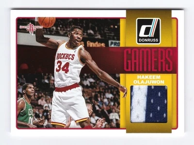 2014-15 Panini Donruss Hakeem Olajuwon Gamers Game-Worn Patch #4 Rockets HOF - Image 1 of 2