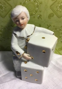 Statuina bambina vintage 4-1/2" in abito da pagliaccio che tiene dadi bianchi con bordo oro - Foto 1 di 8