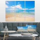 Designart "Large Clouds Over Calm Beach" Seashore Photo Blue 36 In. Wide X 28 In