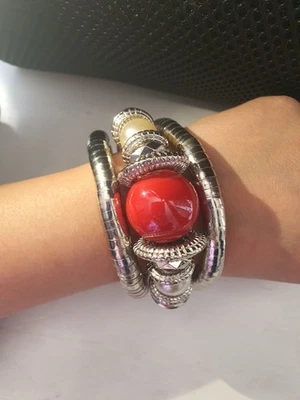 This is a silver-toned cuff bracelet with a large red stone and smaller bead - Image 1 of 4