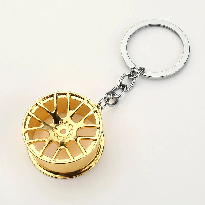 1 Golden alloy wheel hub keychain - Unique car-themed gift keychain pendant Foto 1 de 1