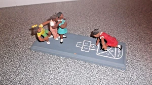 4 girls playing hopscotch on a board figurines - Picture 1 of 5