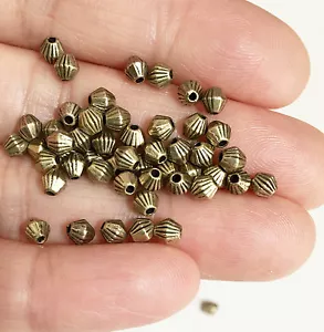 100 Doppelkegel Zwischenperlen 4x3,5mm, Metall Zwischenperlen - in 4 Farben erhältlich - Bild 1 von 17