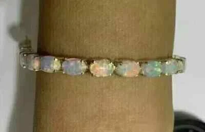 Brazalete de tenis para mujer de ópalo de fuego ovalado de 5 quilates con acabado de oro amarillo de 14 k Foto 1 de 4