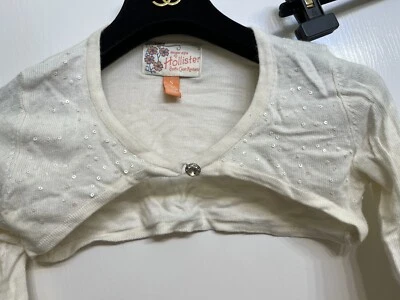 HOLLISTER CRISTAL BOTÓN LENTEJUELAS ENCOGERSE DE HOMBROS SEXY CROP EXTRA L/S MARFIL CÁRDIGAN-SUÉTER Foto 1 de 4