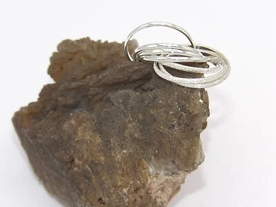 Hecho a mano en EE. UU. 925 Plata de Ley Entrelazada Siete Bandas Anillo Rodante Polvo de Estrellas Foto 1 de 4