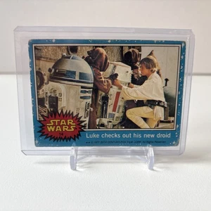 1977 Topps Star Wars Card First Series Blue #14 Luke checks out his new droid - Picture 1 of 3
