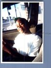FOUND COLOR PHOTO L_9805 PRETTY BLACK GIRL SITTING IN CAR SMILING