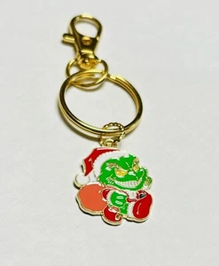 Schlüsselanhänger Grinch inspiriert. Tolle Strumpfwaren. Goldfarben - Bild 1 von 1