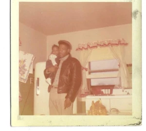 1970's Vintage African American Father Standing with Infant Son in Kitchen - Picture 1 of 1