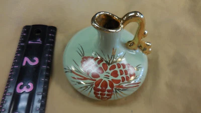 BEAUTIFUL SMALL LIGHT GREEN VASE WITH PINECONES AND GILDED DECORATIONS - Image 1 of 4