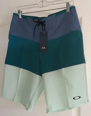 Pantalones Cortos OAKLEY Para Hombre 30 Azul Verde Como Nuevo Cremallera Bolsillo Logo Elastizados NUEVO Foto 1 de 4