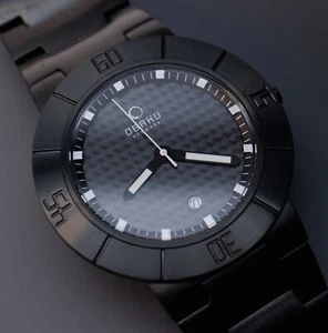 7" Obaku V140GBBSB Black Carbon Fiber Dial Watch Titanium Coated Stainless - Picture 1 of 14