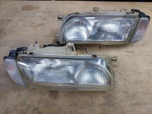 Nissan Avenir W10 Headlights Koito 100-24577 With Cornerlights - Picture 1 of 13