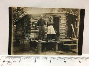 Postcard Wooden House Couple Man Woman Smoking Cigar Barrel Well Pitcher Pump - Picture 1 of 5