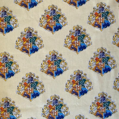 Harry Potter Watercolor Yellow Crest Wizarding World Cotton Fabric - By the Yard - Image 1 of 4