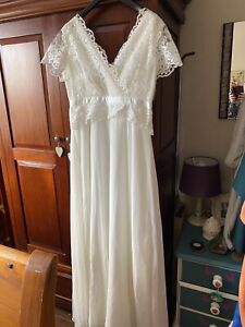 ivory lace wedding dress with a small veil.  Size  14