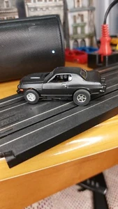Auto World Slot Car -X-Traction Ultra G - Flat Black 1976 Ford Torino - Picture 1 of 7