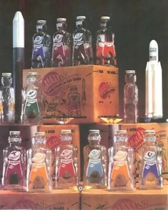 12 GALAXY SPACE FOODS SPACEMAN ASTRONAUT SODA SYRUP BOTTLE COIN BANKS 1953 - Picture 1 of 11