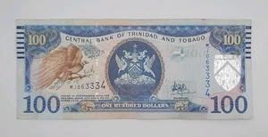 2006 (2016) Bank of TRINIDAD AND TOBAGO - 100 Dollars Banknote No. MJ 063334 - Picture 1 of 2