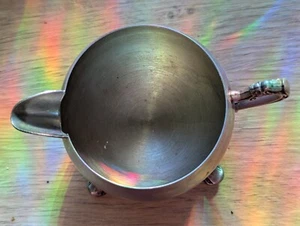 A metal silver toned creamer with Victorian inspired scrolling design. - Picture 1 of 11