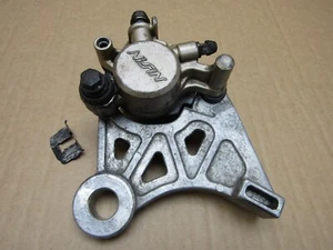 Honda CBR400RR 1988 left brake caliper Nissin with pads (14683) - Picture 1 of 14