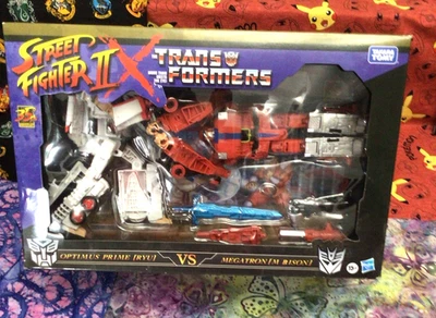 TRANSFORMERS X STREET FIGHTER II OPTIMUS PRIME RYU VS. MEGATRON M. BISON TAKARA - Image 1 of 4