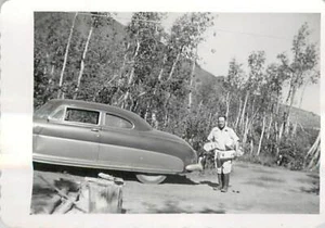 1950s Fishing Camp Man Carrying Wood Firewood Hudson Hornet Vintage B&W Photo - Picture 1 of 2