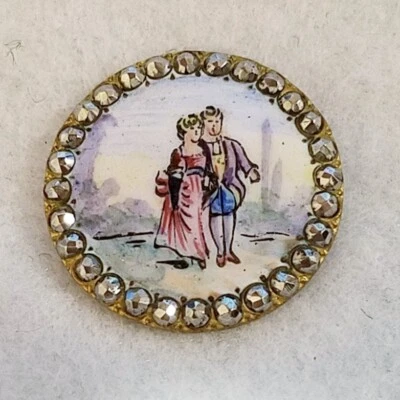 GORGEOUS ANTIQUE PAINTED ENAMEL W/A COUPLE SCENE AND A CUT STEEL BORDER  1-1/18" - Image 1 of 3