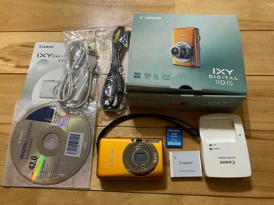 Cámara compacta Canon IXY DIGITAL 110 IS naranja 10 megapíxeles con accesorios Foto 1 de 4